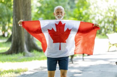Senior-man-holding-Canadian-flag Senior-man-holding-Canadian-flag